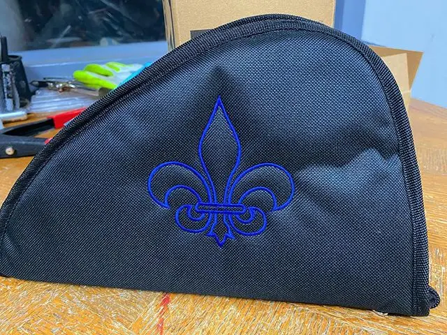 Embroidered gun carrying case with a blue Fleur de Leis.  We can customize your case to any image or text desired.
#guncase #embroideredguncase #fleurdeleis #customizedguncase